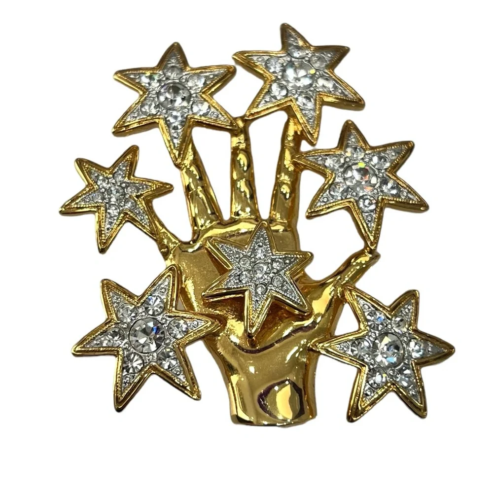 NOLAN MILLER SHINY GOLDEN HAND WITH CRYSTAL STARS BROOCH